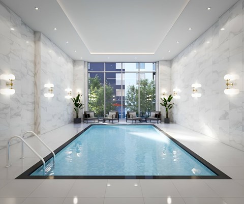 a swimming pool in a room with marble walls and a large window
